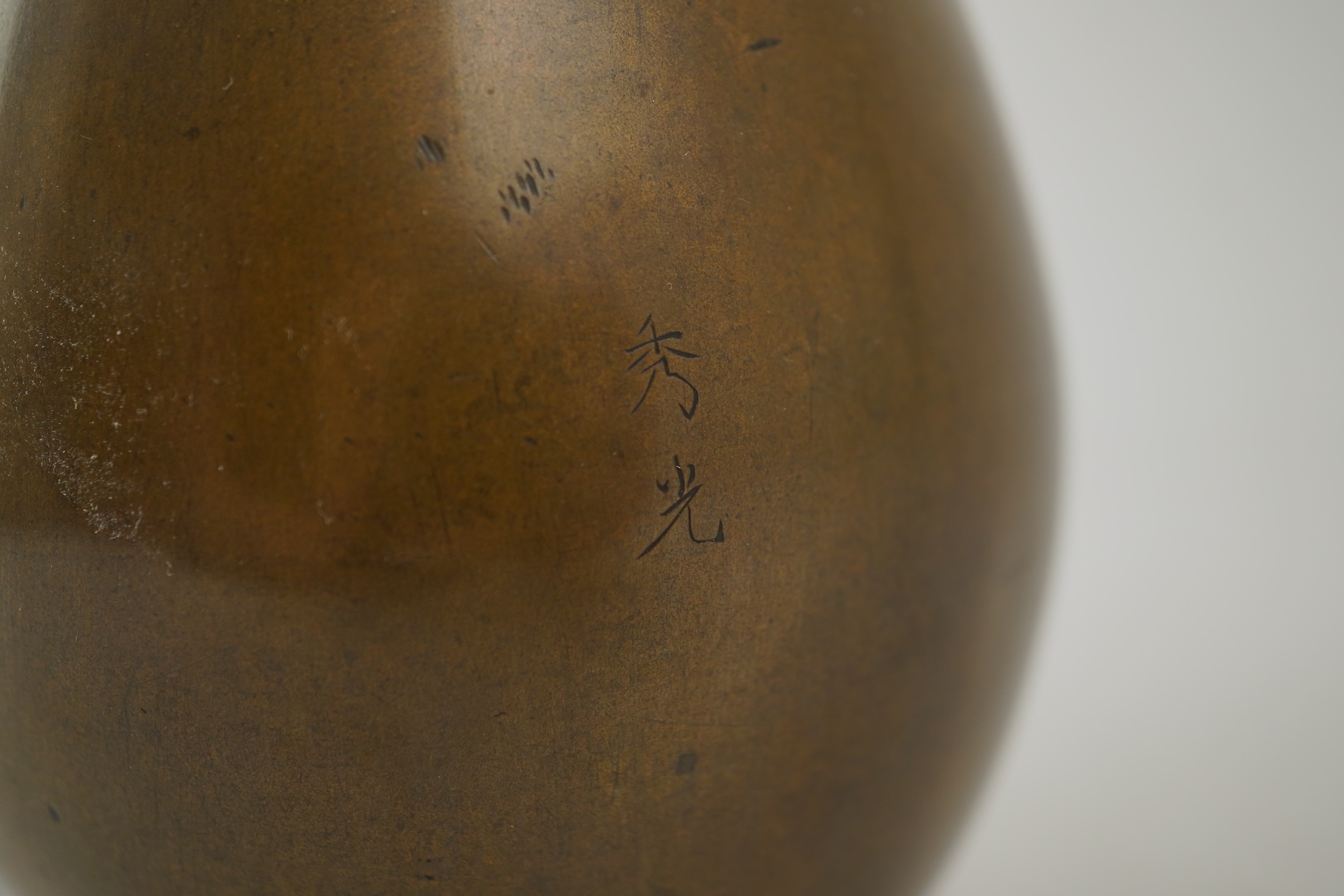 A pair of Japanese bronze and mixed metal inlaid bottle vases, signed Hidemitsu, Meiji period